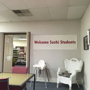 a table and chairs in a room with a welcome sign