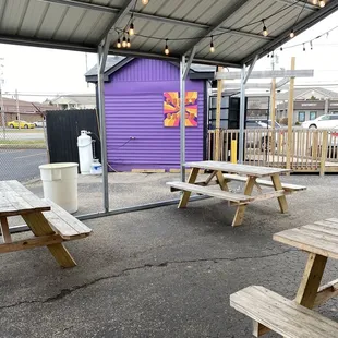a purple building and picnic tables