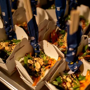 a tray of food with chopsticks sticking out of it
