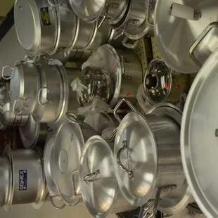 a wall of pots and pans