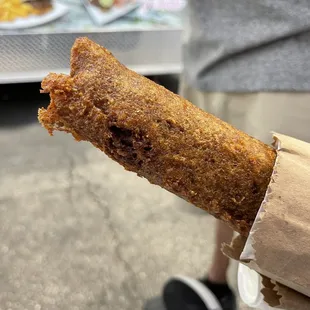 a person holding a piece of food