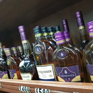 a shelf full of liquor bottles