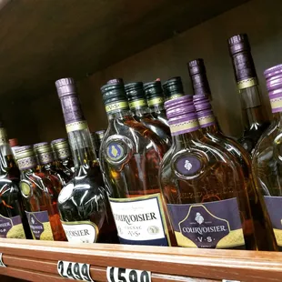 a shelf full of liquor bottles