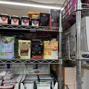 Shelf with sweets next to one of the cashiers and parallel to the deli counter