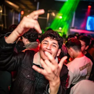 a man making a peace sign with his hands