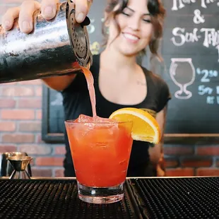a bartender pouring a drink
