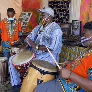 Cute family drumming in The Africa tent.