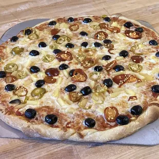 The Lenora: Sweet cherry peppers, pineapple &amp; black olives. Whole milk mozzarella on a homemade crust with a red sauce base. Vegetarian Love