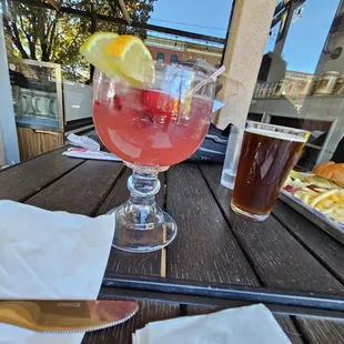 a glass of wine and a plate of fries