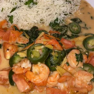 a plate of food with rice and shrimp