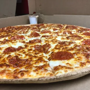 Thin Crust Pepperoni Pizza Served with a Side of Garlic Sauce