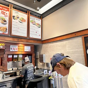 a woman ordering food at a fast food restaurant