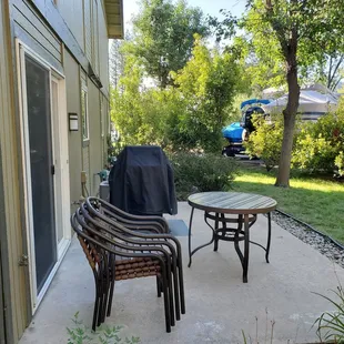 Patio with gas grill. A little buggy at night.