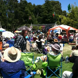 a crowd of people sitting in lawn chairs