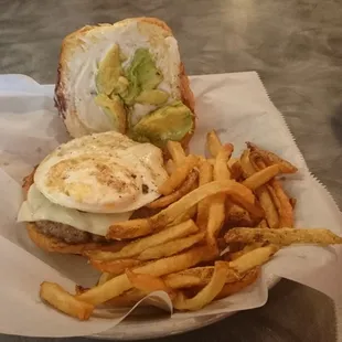 Brazilian burger and fries.  Wonderful beef patty, Swiss cheese, bacon, fried egg, and avocado with mayo on a lightly toasted bun.  YUM!!