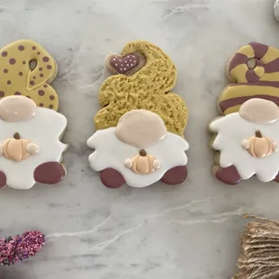 three decorated cookies on a table