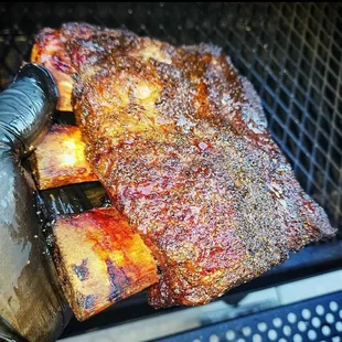 ribs being cooked on the grill
