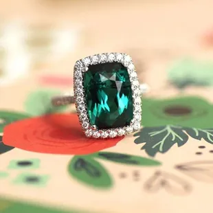Glamorous green tourmaline halo ring set in white gold from Coast Diamond Jewelry, style number LSK10075-GT