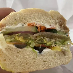 a hand holding a sandwich