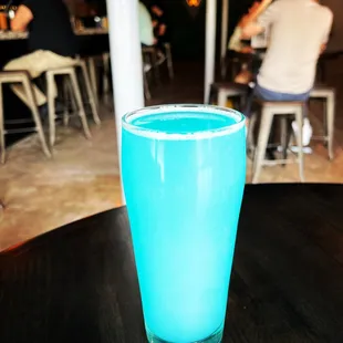 a blue drink in a tall glass