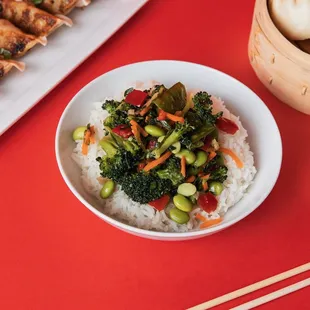 a bowl of rice and a plate of dumplings