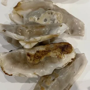 These are the undercooked potstickers, the white parts are the hard undercooked dough.