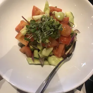 Spring salad with tomato cucumbers onion and avocado