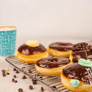  donuts and drips on a cooling rack