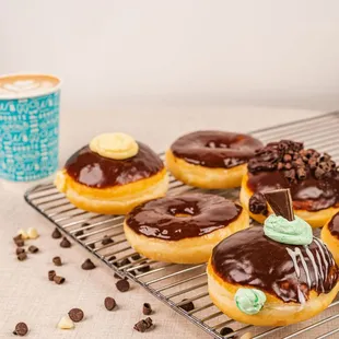  donuts and drips on a cooling rack