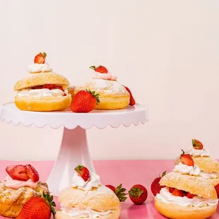  donuts and strawberries on a cake stand