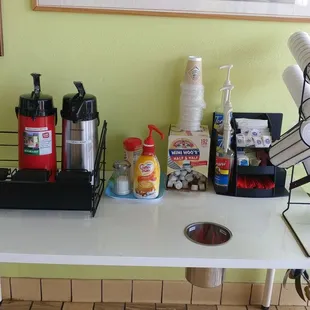 a table with coffee and condiments