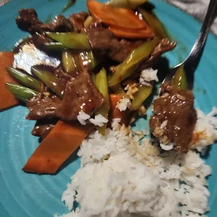 Szechuan beef with fluffy steamed rice. Mild spicy. So delicious