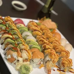 a plate of sushi and rolls