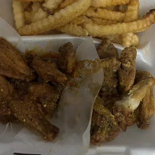 a basket of chicken wings and french fries