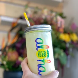 a hand holding a drink