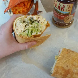 a hand holding a sandwich