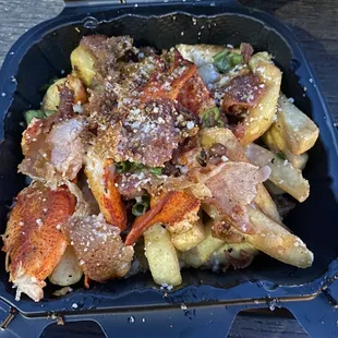 Potato styxx, load em&apos; (cheese sauce, parmesan cheese, bacon, and lobster.
