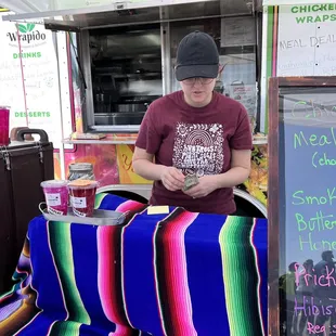 a man standing in front of a food truck
