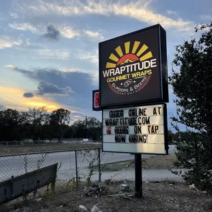 a sign in front of a chain link fence