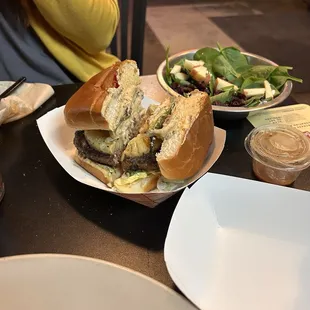 Pecan cranberry salad with giant burger with fresh ingredients and delicious meat