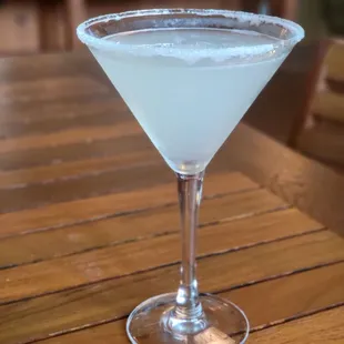 a glass of white liquid on a wooden table