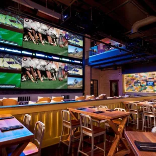 a sports bar with multiple screens