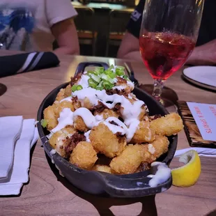 a bowl of food and a glass of wine