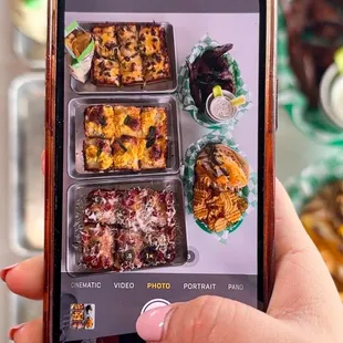 a person taking a picture of their food