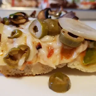 Side view of Veggie Lover&apos;s pizza ($20+$3 for vegan cheese). Great crust. Good texture &amp; flavor from Glenview Farms vegan cheese.