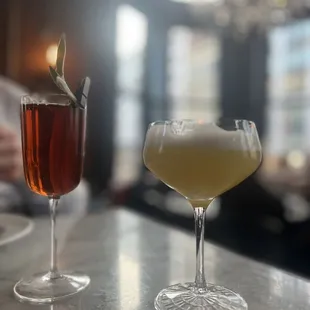 two cocktails on a bar