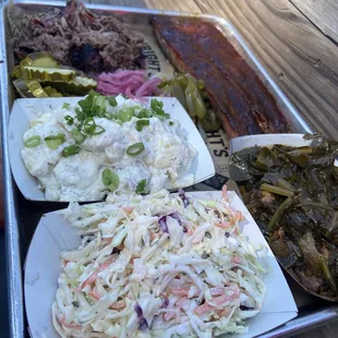 Two meat plate + extra side: creamy coleslaw, ranch potato salad, collard greens, pickled veggies, , chopped brisket.