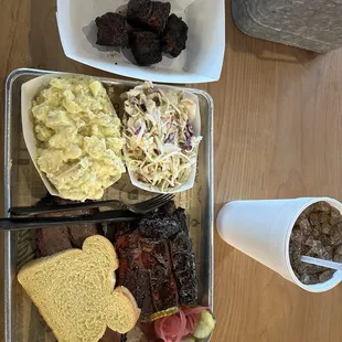 Brisket with ribs, deviled egg potato salad, and coleslaw.