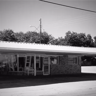 a black and white photo of a gas station