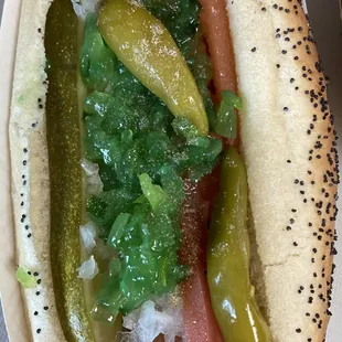 a hot dog with pickles and onions